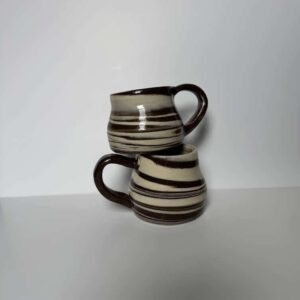 Handmade ceramic mugs with brown and cream striped glaze, rustic pottery coffee cups
